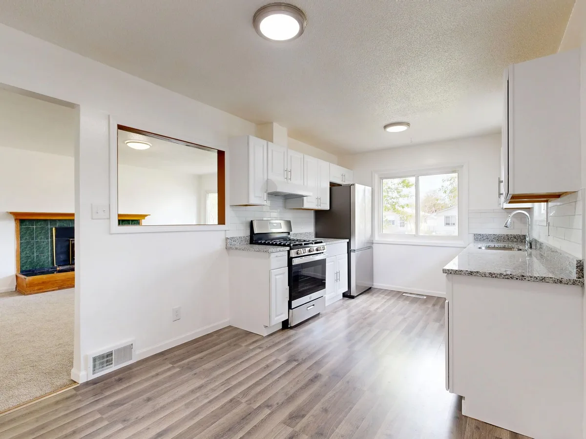 Fully remodeled kitchen with new cabinets, island and lighting on the North Shore of MA