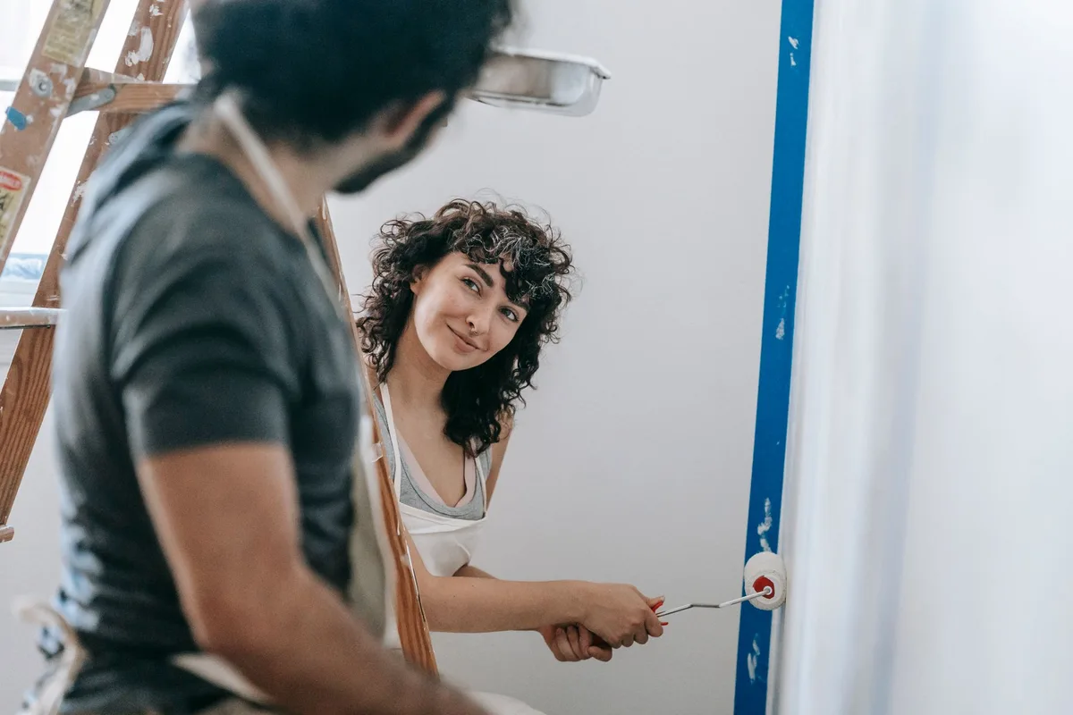 Painter rolling fresh paint on an interior wall