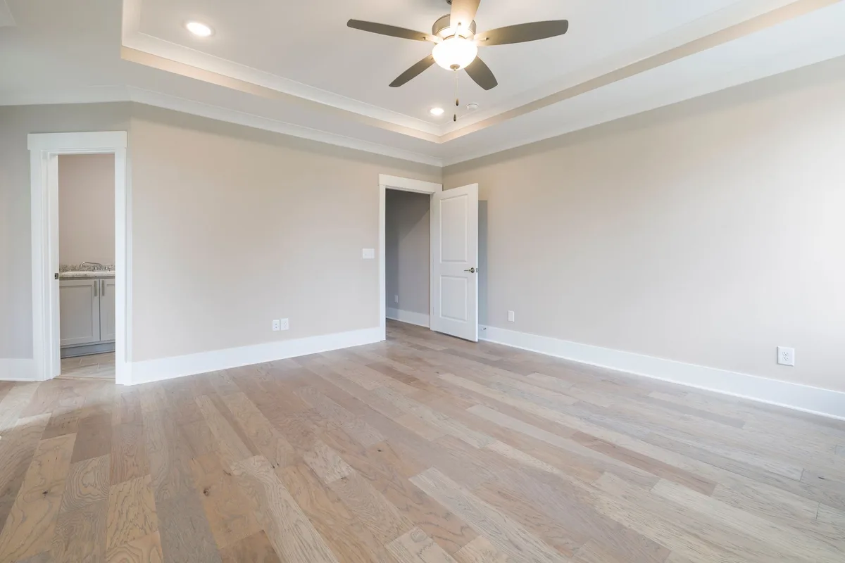 White baseboard trim along a hardwood floor